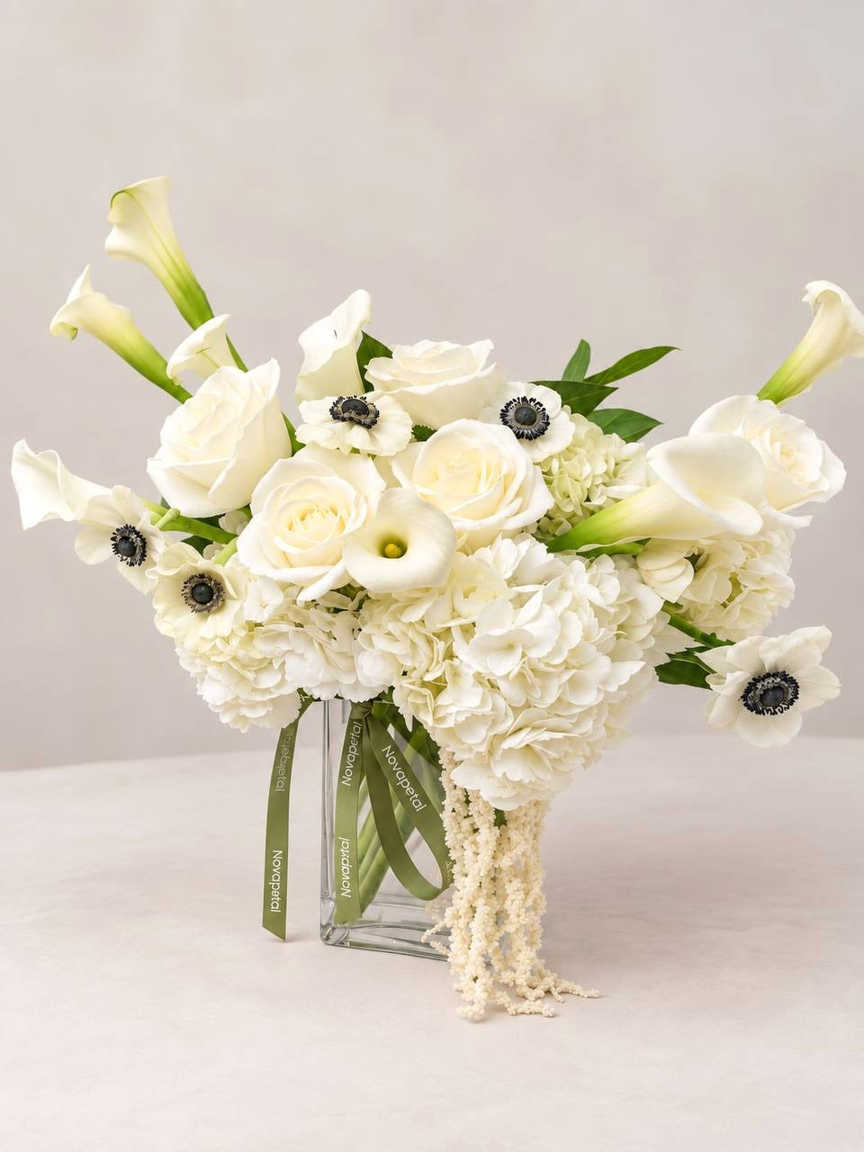 Calla Noir large: white calla lilies, anemones with black centers, hydrangea and cream roses with the Novapetal ribbon, New York