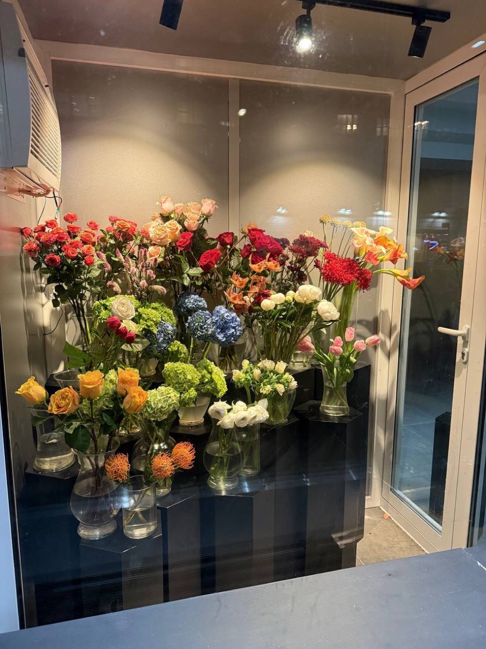 Fresh roses, hydrangea, tulips and ranunculus in glass vases inside the Novapetal studio in Manhattan