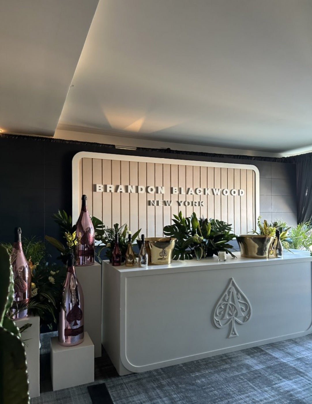 Greenery and champagne display styled for a brand activation in New York