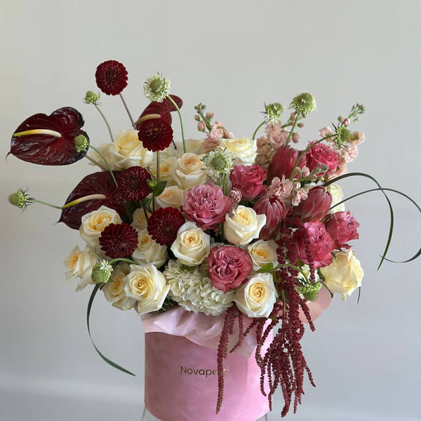 Bouquet with delicate pink and white ranunculi in a transparent vase