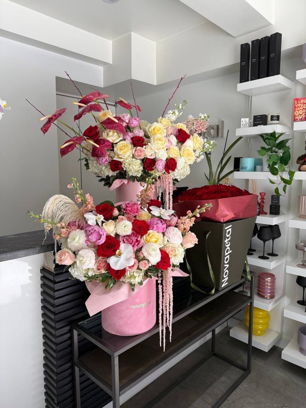Luxury hat box arrangements and a red rose box displayed inside the Novapetal studio in New York