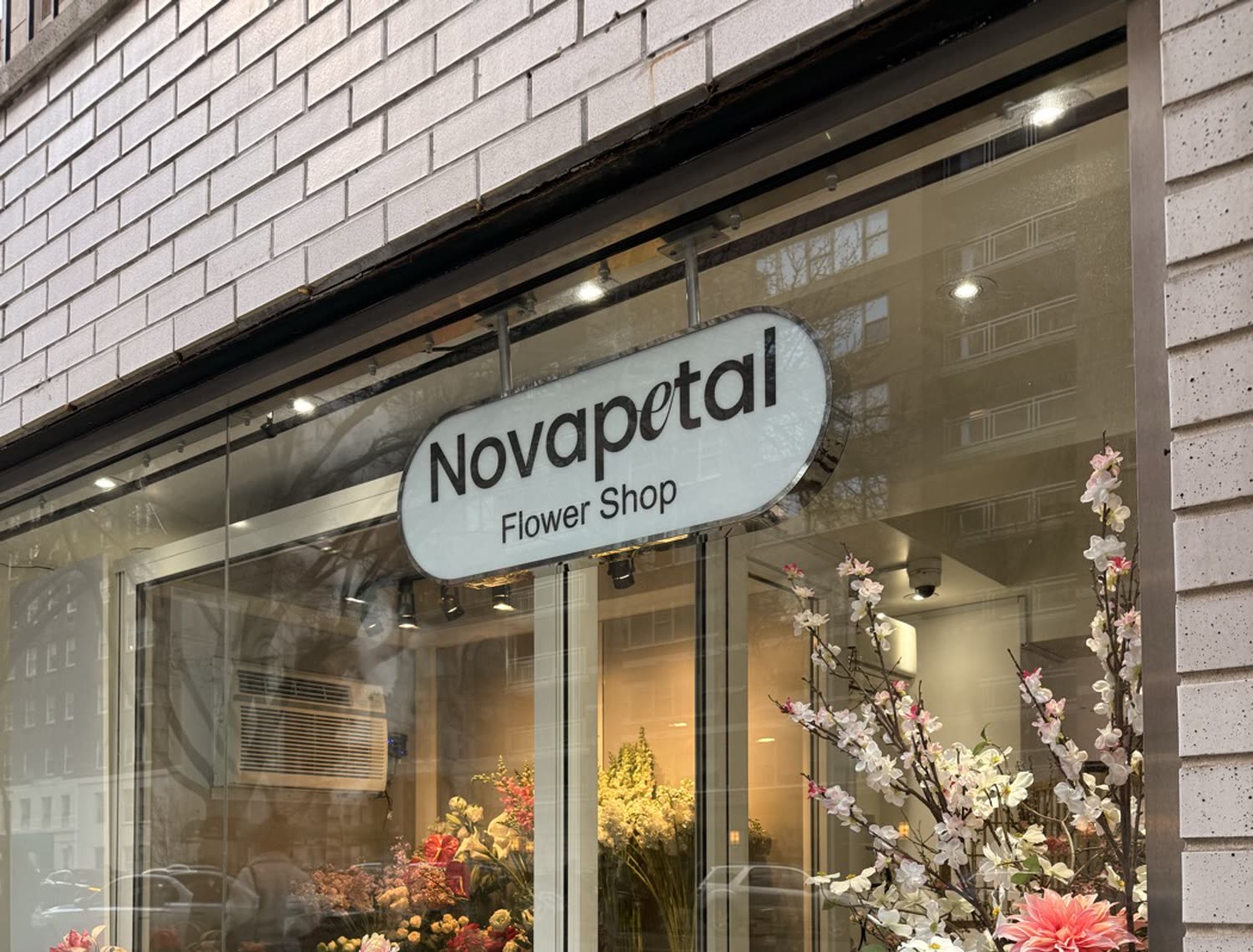 The Novapetal Flower Shop window on East 72nd Street in New York, filled with flowers behind the glass