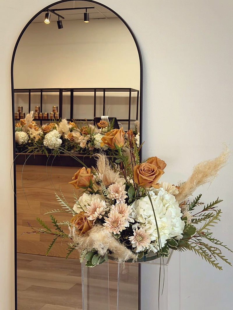Toffee roses pampas grass and white hydrangea in a boho centrepiece