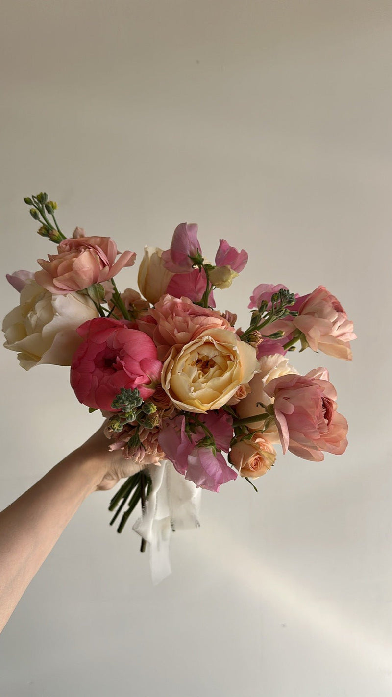 Blush and coral garden rose bouquet with sweet pea and stock